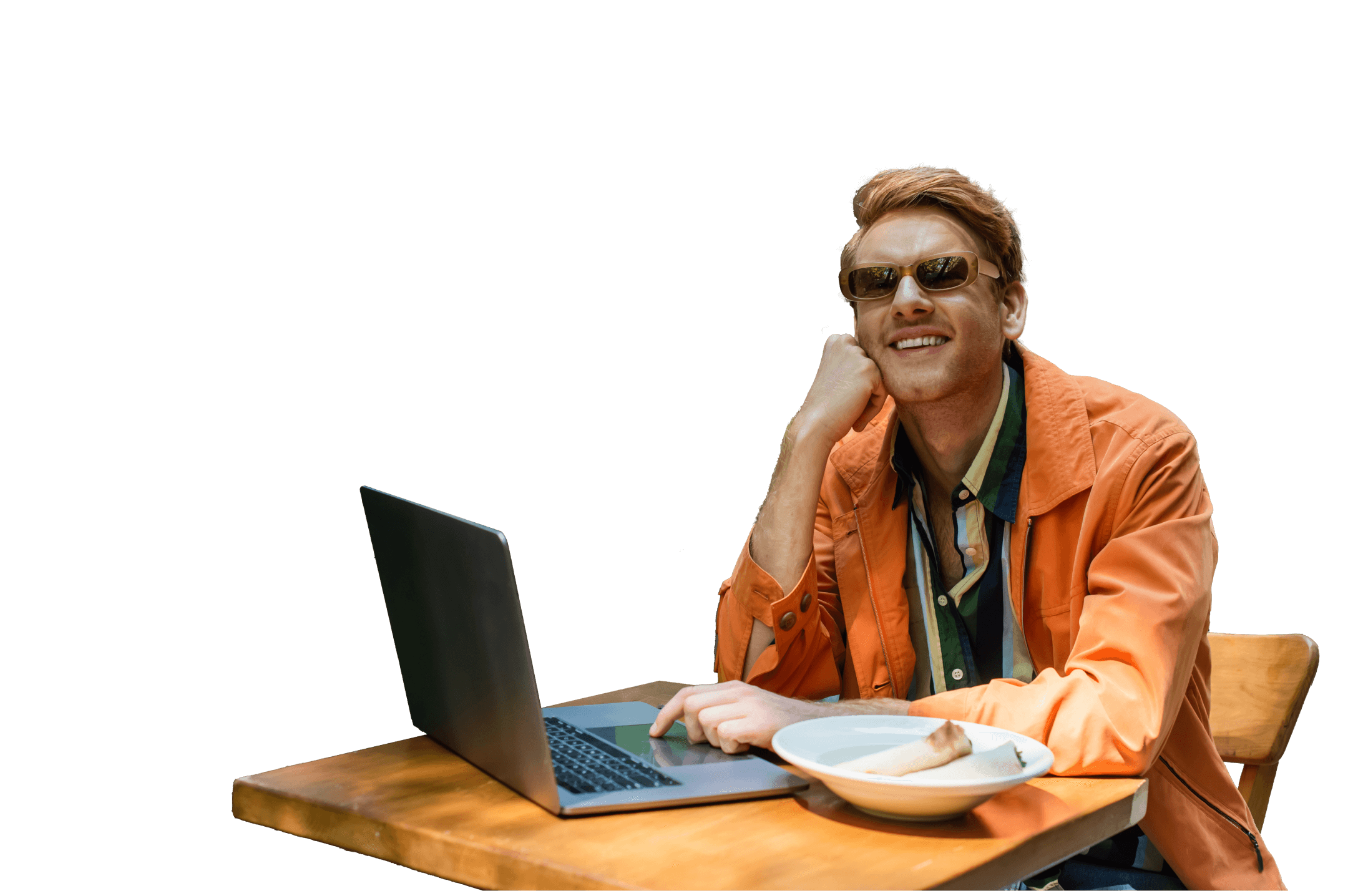 Freelancer using laptop at a table outdoors