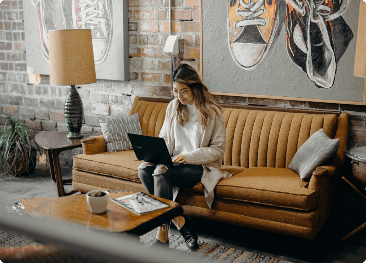 Woman using laptop on a couch